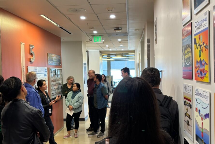 Group of persons in a hallway gathered around person leading tour of The Molecular Foundry at Berkeley Lab