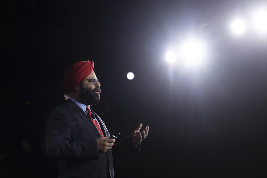 Person standing and lecturing with bright lights to the side