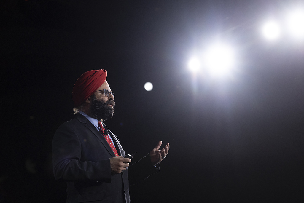 Person standing and lecturing with bright lights to the side