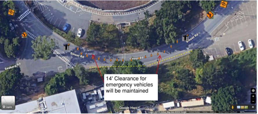 Aerial view of Smoot Road with one lane closed as indicated by orange hazard cones and flagger markers, with a label pointing to closed area with words "14' Clearance for emergency vehicles will be maintained"