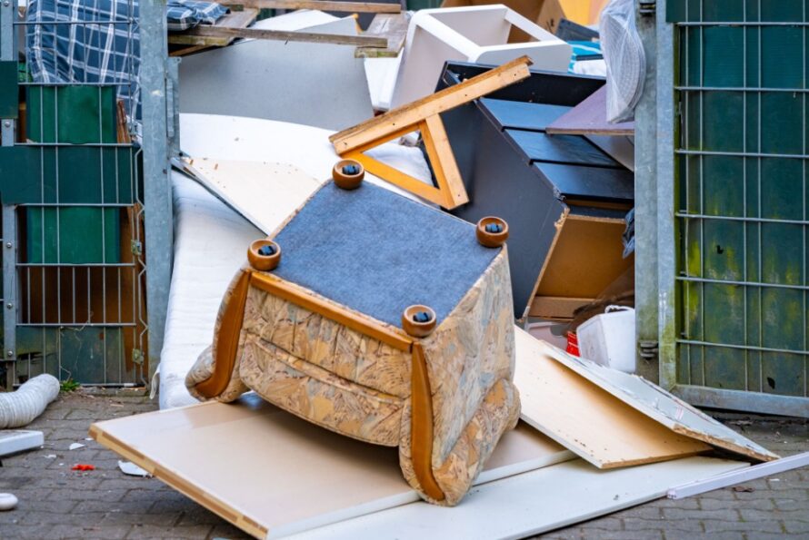 A pile of discarded furniture in a bulk waste facility.