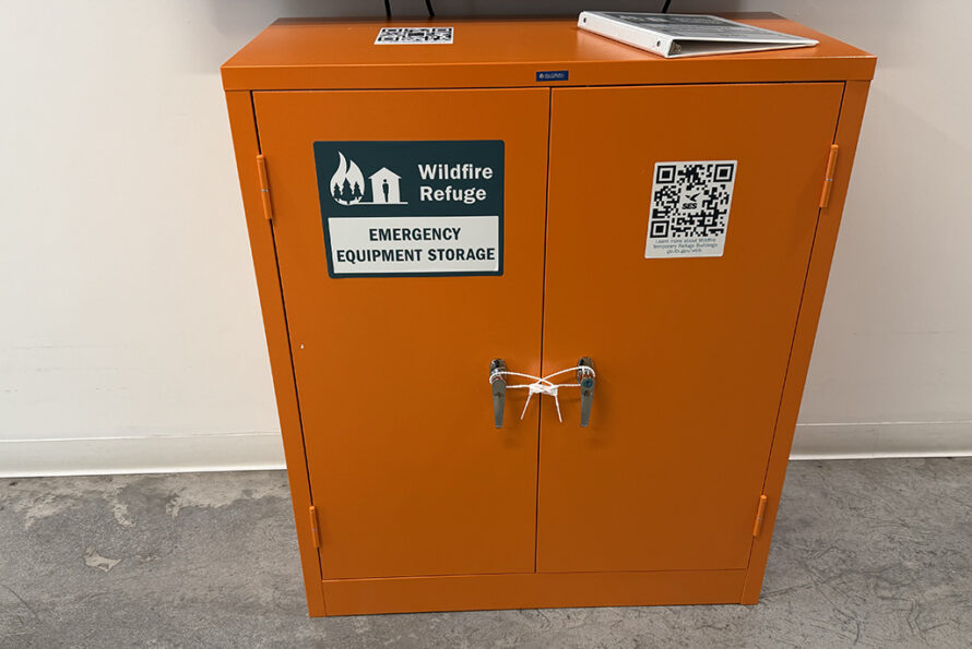 Bright orange cabinet with stickers on it