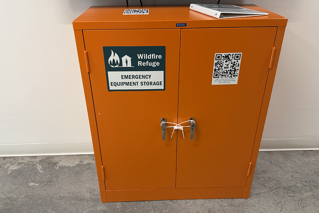 Bright orange cabinet with stickers on it