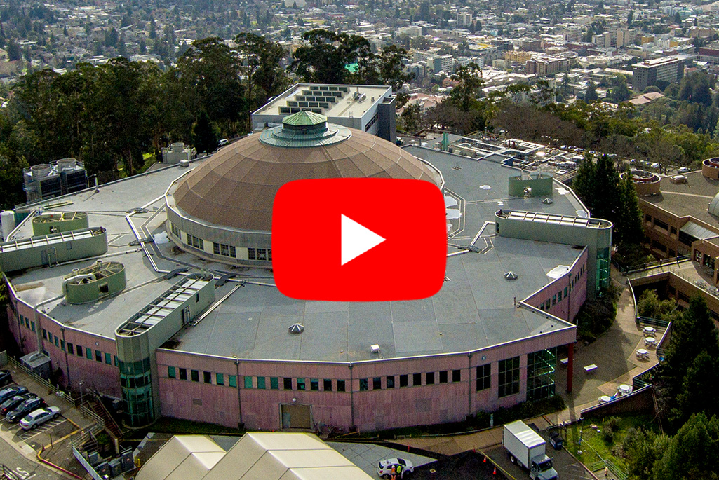aerial photo of building with red play arrow on top