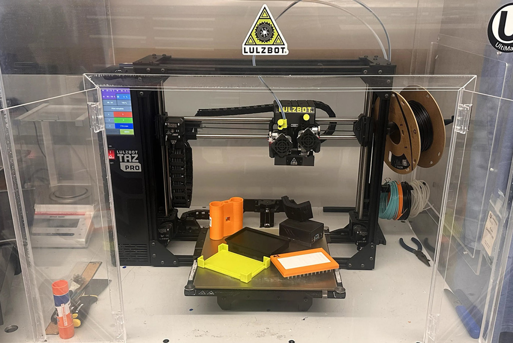 3d printer with 3d printed materials on top.