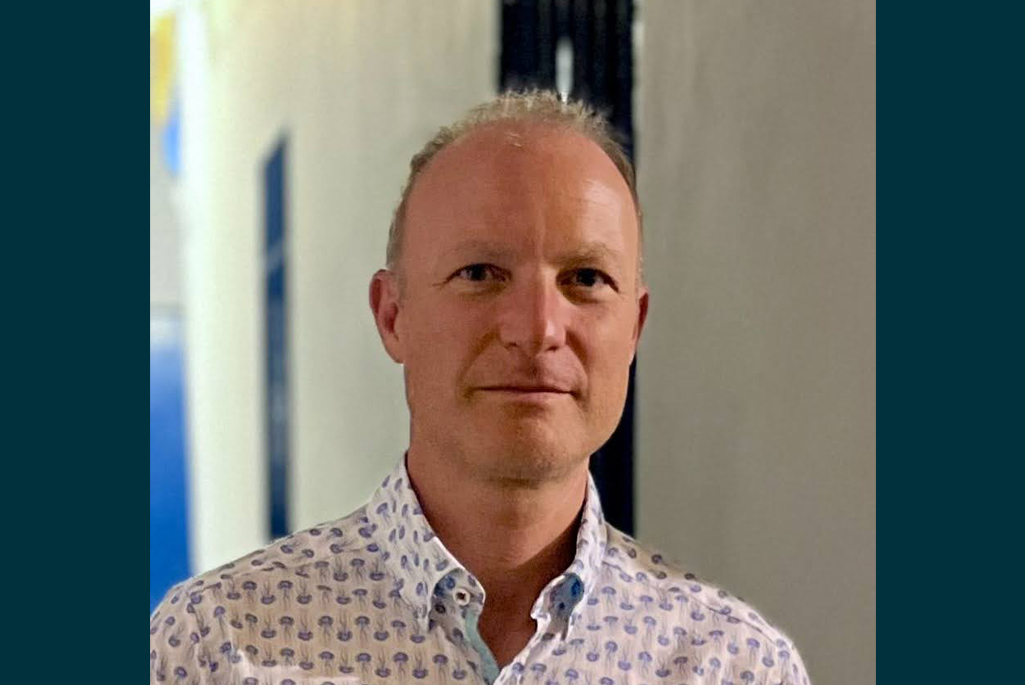Person with short blonde hair and a white patterned dress shirt who is Head of Physics Division Theory and Quantum Computing Groups.