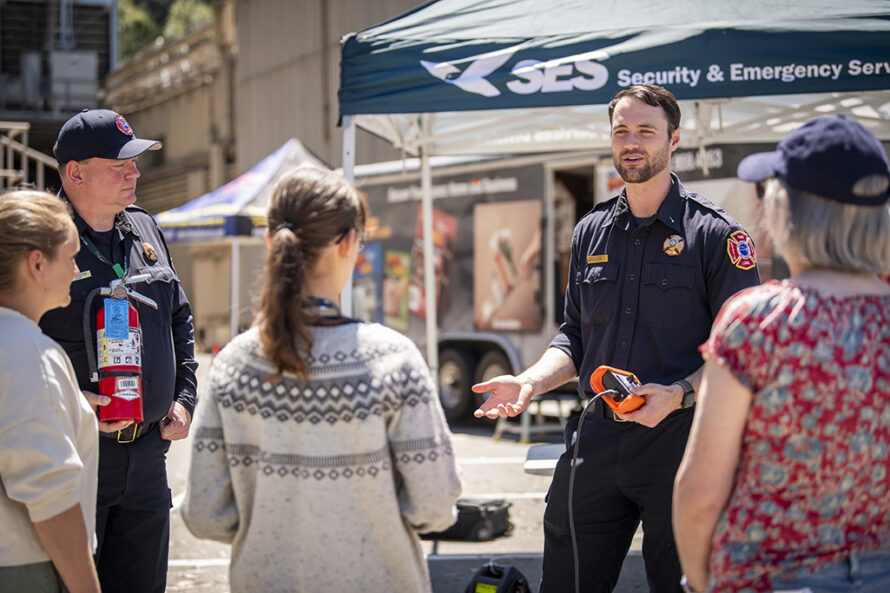 Person in uniform talking with group