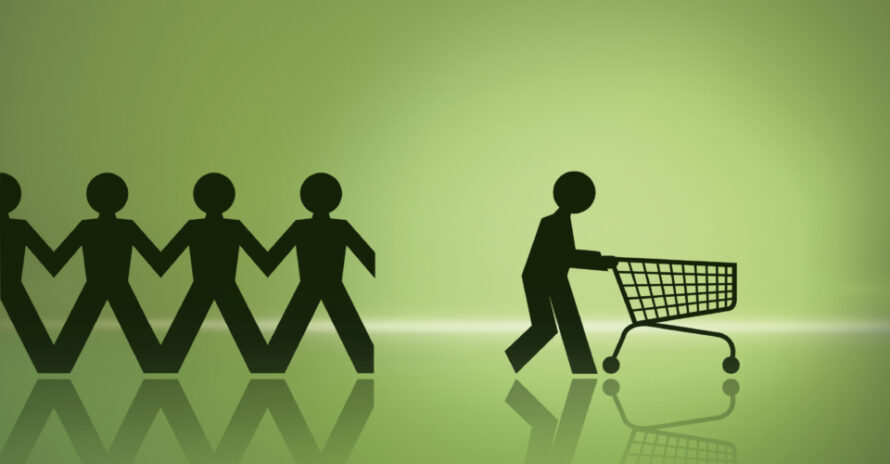 Black paper cutouts of people holding hands with one separate pushing shopping cart to convey buying theme.